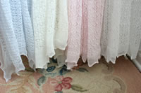 All four colors of lacy blankets side by side