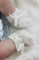 White booties modelled on a doll