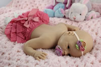 Full body silicone doll lying on tummy