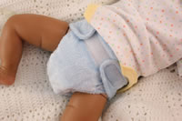 Blue Plumpie Rumpie diaper modelled on a doll