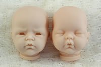 Two unpainted doll heads of Lilliana and Adelynn